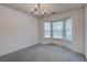 Empty living room featuring bay window and a modern chandelier fixture at 1341 Belle Grove Cir, Hanahan, SC 29410