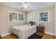 Bright bedroom with hardwood floors, two windows, and a ceiling fan at 14 Newark Ave, Goose Creek, SC 29445