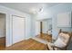 Light blue bedroom with hardwood floors, large mirror, and bright natural light at 14 Newark Ave, Goose Creek, SC 29445