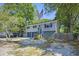 Charming two-story home with an American flag and mature trees at 14 Newark Ave, Goose Creek, SC 29445