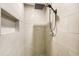 Tiled walk-in shower showcases rainfall showerhead and convenient recessed storage at 14 Newark Ave, Goose Creek, SC 29445