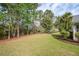 Wide backyard with plenty of green space, perimeter landscaping, and mature trees offering ample shade at 1409 Endicot Way, Mount Pleasant, SC 29466