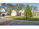 Well-maintained single-story house boasts a pristine lawn, two-car garage, and neatly trimmed shrubs at 1409 Endicot Way, Mount Pleasant, SC 29466