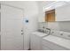 Bright laundry room with washer, dryer, and overhead cabinets at 1409 Endicot Way, Mount Pleasant, SC 29466
