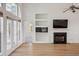 Cozy living room boasting wood floors, fireplace, and custom built-in shelving for stylish storage at 1409 Endicot Way, Mount Pleasant, SC 29466