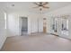 Expansive living room offering neutral carpet, a ceiling fan, and French doors providing access to the backyard at 1409 Endicot Way, Mount Pleasant, SC 29466
