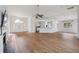 Open-concept living area with wood floors, seamlessly connecting the entrance, kitchen, and living space at 1409 Endicot Way, Mount Pleasant, SC 29466