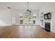 Spacious living room filled with natural light, complemented by wood floors and a cozy fireplace at 1409 Endicot Way, Mount Pleasant, SC 29466