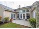 Exterior view of a patio featuring a chimney and several sets of French doors allowing ample natural light at 1409 Endicot Way, Mount Pleasant, SC 29466