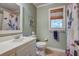 This bathroom features a neutral color palette, tiled floors, and a window to allow natural light to fill the space at 1417 Pine Island View, Mount Pleasant, SC 29464