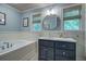 Elegant bathroom featuring a soaking tub, vanity with counter space, and a bright, refreshing atmosphere at 1417 Pine Island View, Mount Pleasant, SC 29464