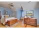 Bright bedroom with hardwood floors, a four-poster bed, and a window seat at 1417 Pine Island View, Mount Pleasant, SC 29464