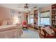 Adorable pink bedroom with built-in shelves, a white iron bed, and charming decor at 1417 Pine Island View, Mount Pleasant, SC 29464