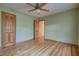 Simple bedroom with hardwood floors, ceiling fan, and neutral color scheme at 1417 Pine Island View, Mount Pleasant, SC 29464