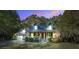 Inviting two-story home with a cozy front porch and lush landscaping at dusk at 1417 Pine Island View, Mount Pleasant, SC 29464