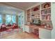 Bright home office with custom built-in shelving, hardwood floors, and an inviting view to the backyard at 1417 Pine Island View, Mount Pleasant, SC 29464