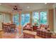 Comfortable living room featuring a dining table, large windows, and cozy seating with plaid armchairs at 1417 Pine Island View, Mount Pleasant, SC 29464