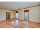 Large living room with hardwood floors, neutral paint, and plenty of natural light from two large windows at 1417 Pine Island View, Mount Pleasant, SC 29464