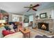 Comfortable living room with brick fireplace, hardwood floors, and views into the dining area at 1417 Pine Island View, Mount Pleasant, SC 29464