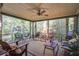 Inviting screened porch with comfortable seating, ceiling fan, and views of the lush backyard at 1417 Pine Island View, Mount Pleasant, SC 29464