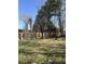 Fenced backyard with mature trees and green grass at 142 Aylesbury Rd, Goose Creek, SC 29445