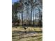 Grill and firepit in a spacious backyard with mature trees at 142 Aylesbury Rd, Goose Creek, SC 29445
