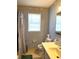 Bathroom with sink, commode, blinds and decorative wallpaper at 142 Aylesbury Rd, Goose Creek, SC 29445