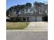 Charming single-story home with a well-manicured lawn and a two-car garage at 142 Aylesbury Rd, Goose Creek, SC 29445