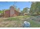 Spacious backyard featuring a brick chimney, a screened-in porch, a slide, and mature trees at 1421 Fairfield Ave, Charleston, SC 29407
