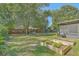 A spacious backyard featuring a screened-in porch, a playset, a hammock, and raised garden beds at 1421 Fairfield Ave, Charleston, SC 29407