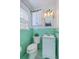 Mint-green bathroom featuring vintage tiles, vanity, and plant decor at 1421 Fairfield Ave, Charleston, SC 29407