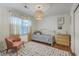 Charming bedroom with hardwood floors, a daybed, and a unique woven pendant light fixture at 1421 Fairfield Ave, Charleston, SC 29407