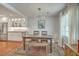 Bright dining area featuring a rustic wooden table, stylish decor, and an open view to a modern kitchen at 1421 Fairfield Ave, Charleston, SC 29407