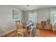 Elegant dining room with hardwood floors, a modern chandelier, and large windows, creating a perfect space for gatherings at 1421 Fairfield Ave, Charleston, SC 29407