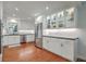 Bright, open kitchen with hardwood floors, stainless steel appliances and stylish white cabinets at 1421 Fairfield Ave, Charleston, SC 29407