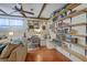 Living room with built-in shelves and workspace, plus wooden ceiling beams and ample lighting at 1421 Fairfield Ave, Charleston, SC 29407