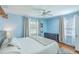 Bright main bedroom with three windows, hardwood floors, and a stylish gray dresser at 1421 Fairfield Ave, Charleston, SC 29407