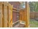 Outdoor shower featuring a wooden enclosure, a stone base, and connections to the house's water supply at 1421 Fairfield Ave, Charleston, SC 29407