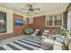 Cozy patio featuring a brick wall, comfortable seating, and outdoor entertainment at 1421 Fairfield Ave, Charleston, SC 29407