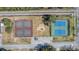 Overhead view of tennis courts, a playground, parking, and surrounding landscaping at 1450 E Montague Ave, North Charleston, SC 29405