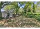 Expansive backyard featuring a shady tree, seating swing, storage building, and partial fence at 1450 E Montague Ave, North Charleston, SC 29405