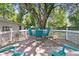 Backyard view of the white-fenced wooden deck area featuring ample seating and a mature shade tree at 1450 E Montague Ave, North Charleston, SC 29405