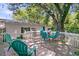 Backyard view featuring a white-fenced wooden deck with seating and string lights in a mature shade tree at 1450 E Montague Ave, North Charleston, SC 29405