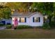 Charming single-story home with a bright pink front door, black shutters, and a well-maintained lawn at 1450 E Montague Ave, North Charleston, SC 29405