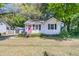 Charming single-story home with a bright pink front door, black shutters, and well-manicured landscaping at 1450 E Montague Ave, North Charleston, SC 29405