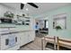 Open concept kitchen with stainless steel appliances and dining area leading into the living room at 1450 E Montague Ave, North Charleston, SC 29405