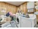 Laundry room featuring a washing machine, dryer, storage containers and other laundry supplies at 1450 E Montague Ave, North Charleston, SC 29405