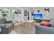 Cozy living room with plush seating, neutral decor, and a view into a modern kitchen with open shelving at 1450 E Montague Ave, North Charleston, SC 29405