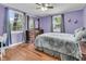Bedroom with hardwood floors, large windows, and dresser featuring a mirror above at 1450 E Montague Ave, North Charleston, SC 29405