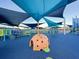 A modern playground with covered shade featuring climbing domes and interactive play equipment for children at 1450 E Montague Ave, North Charleston, SC 29405